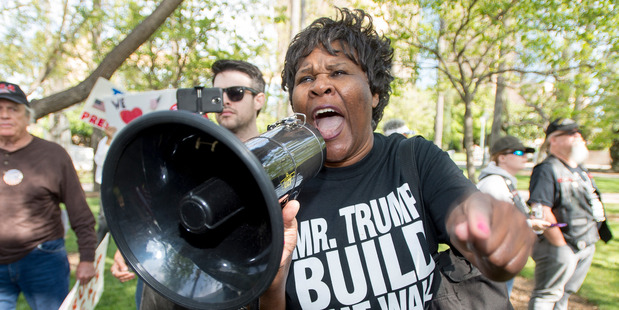 Republican presidential candidate Donald Trump supporter Chanell Temple yells at anti-Trump protesters during a rally in front of the Anaheim City Hall in Anaheim, California. Photo / AP
