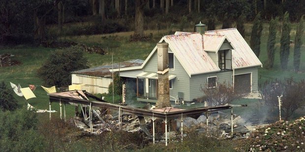 Seascape Cottage, where Martin Bryant held several people hostage, smolder on April 29, 1996 near Port Arthur, Australia. Photo / AP