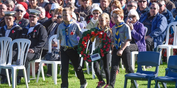 Children from Tauranga Scouts approach the memorial wall at Memorial Park to lay a wreath at this morning's Civic Ceremony. Photo/George Novak