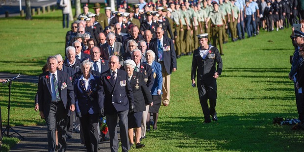 A long line of dignitaries and soldiers old and young make their way to Memorial Park for this morning's Civic Ceremony. Photo/George Novak