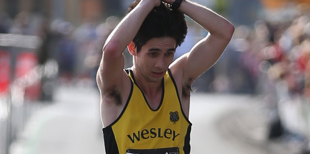 Tony Payne crosses the finish line in third place during the Auckland Marathon 2012. Photo / Getty Images