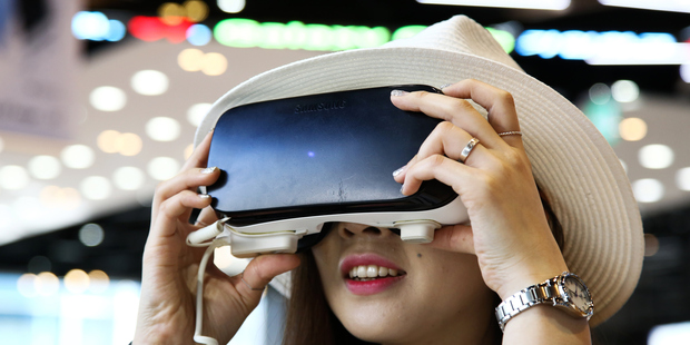 A customer tries a Samsung Electronics Co. Gear VR virtual reality headset at one of the company's digital plaza stores in Seoul, South Korea. Photo / Bloomberg