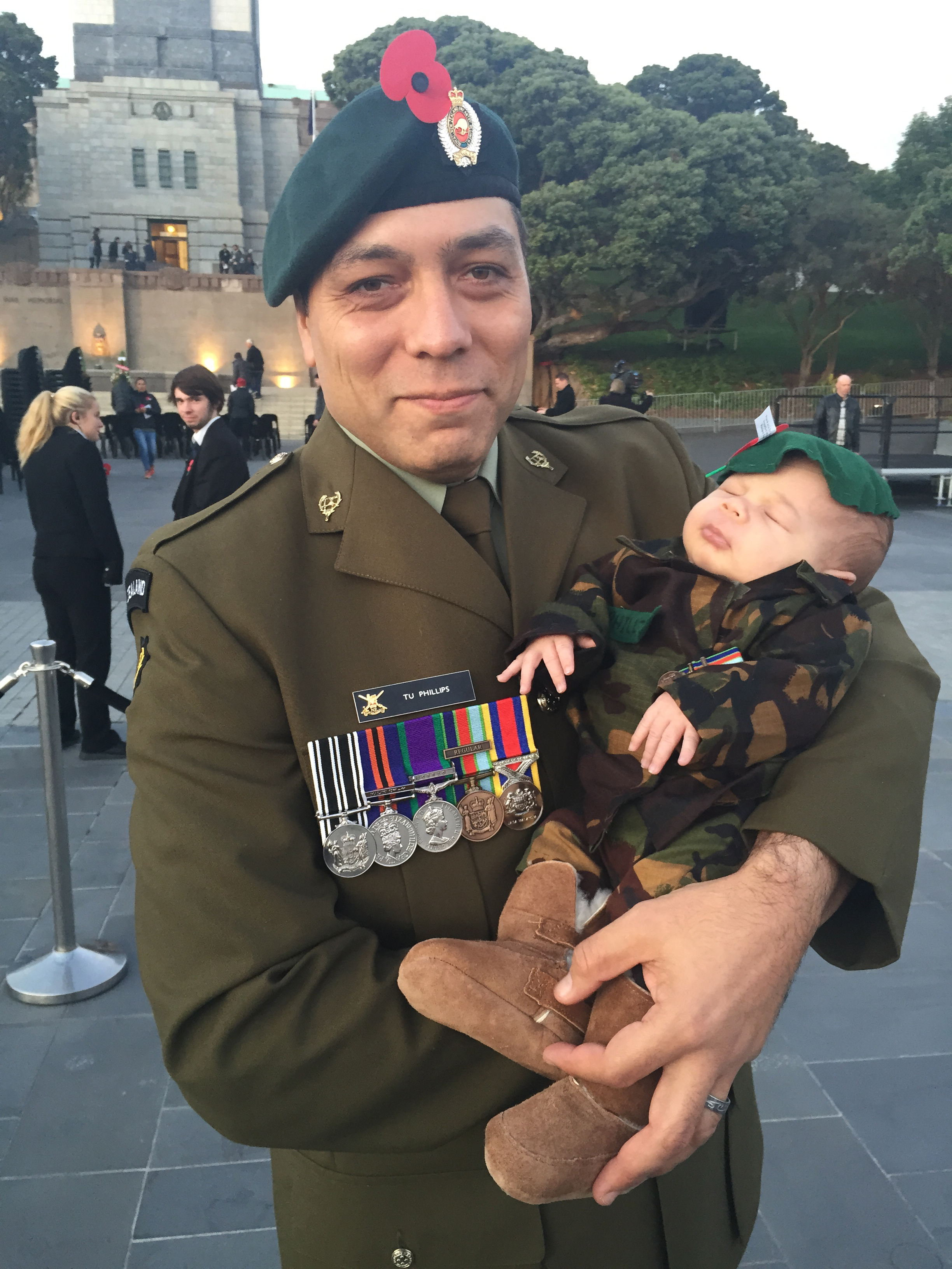 Rawiri Phillips peacefully slept at the end of the service in Tukotahi Phillips' arms. Photo / Mark Mitchell