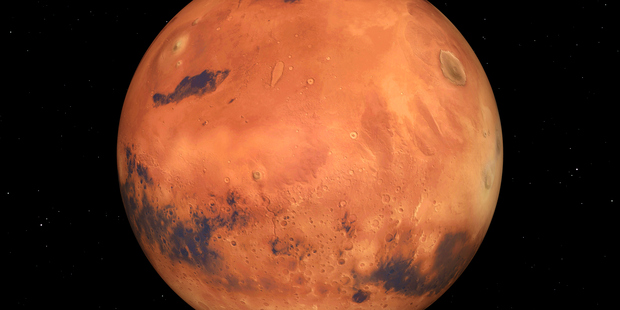 Mars should already appear brighter than normal to star-gazers and good telescopes should be able to make out some of its features. Photo / Getty Images