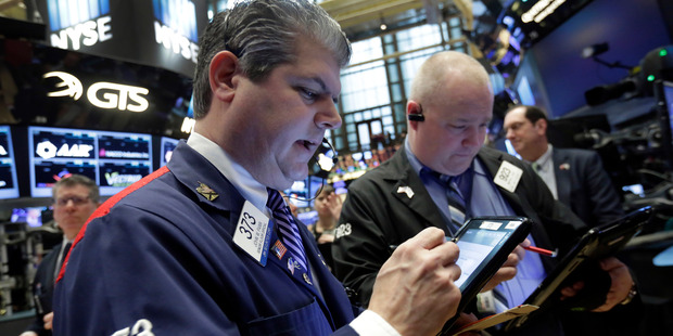 Trader John Panin, left, works on the floor of the New York Stock Exchange. File photo / AP