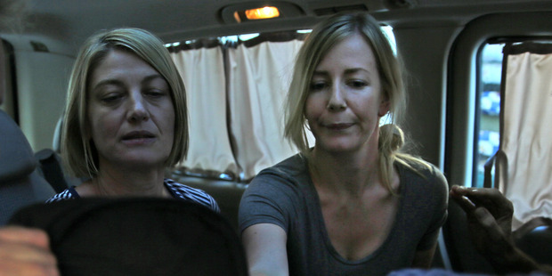 Australian TV journalist Tara Brown, left, and Sally Faulkner, right, the mother of the two Australian children, sit in a minivan after they released from a Lebanese jail. Photo / AP