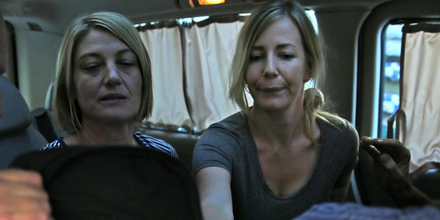 Australian TV journalist Tara Brown, left, and Sally Faulkner, right, the mother of the two Australian children, sit in a minivan after they released from a Lebanese jail. Photo / AP