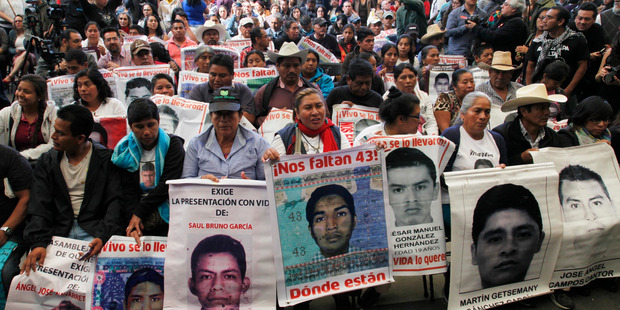 Relatives of the 43 missing students listen to the international experts group's report, in Mexico City. Photo / AP