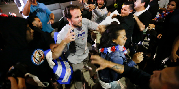 A Trump supporter clashes with protesters outside a rally for Republican presidential candidate Donald Trump. Photo / AP