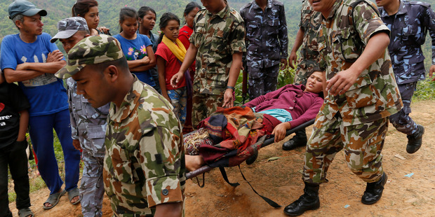 Sita Karka, who suffered two broken legs in last year's massive earthquake, arrives by helicopter from the heavily-damaged Ranachour village. Photo / AP