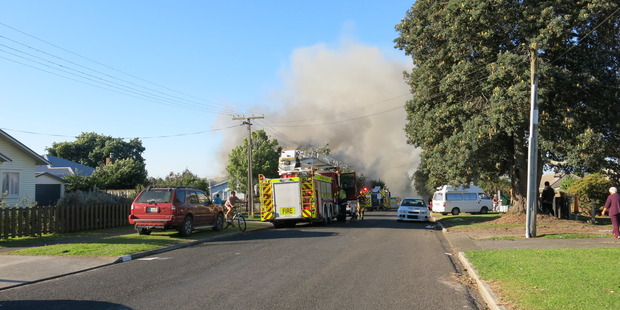 Firefighters arrive at Harris St, Te Puke, where a house is on fire. Photo/Pauline Carney