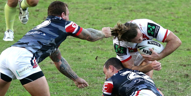 Mitch Rein of the Dragons has his hair pulled in an attempted tackle by Jake Friend of the Roosters. Photo / Getty