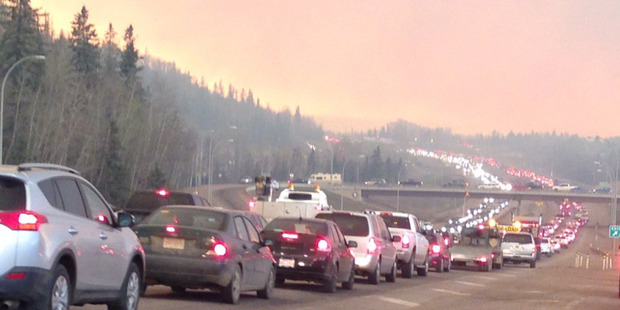 Queues of traffic on the highways as residents try to flee the Fort McMurray fire. Photo / Twitter