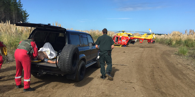 Auckland Westpac rescue helicopter crewman attend to a Male in his 50's who hit a deer at the wood hill dirt bike park. Photo / Supplied
