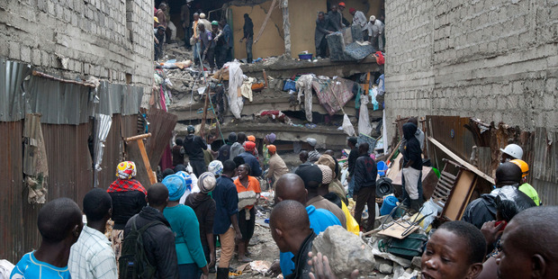 People help survivors retrieve their household items at the site of a building collapse in Nairobi, Kenya. Photo / AP