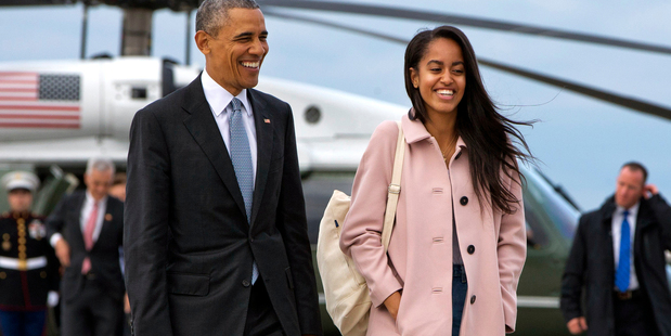 President Barack Obama jokes with his daughter Malia Obama as they walk to board Air Force One from the Marine One helicopter in Chicago last month. Photo / AP