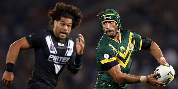 Jonathan Thurston of the Kangaroos is chased by Adam Blair of the Kiwis. Photo / Getty