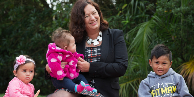 Labour MP Sue Moroney sits with ... who joined others for a protest picnic at Alberton Reserve in Parnell where they made a giant Mother's Day card for Prime Minister John Key. Photo / Greg Bowker