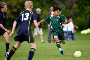 Vincent Phirun, 13, in action for Mount Maunganui under-13s against Aquinas College. Photo / George Novak
