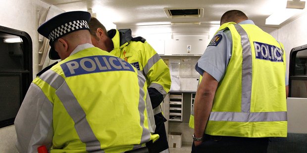 Police officers on 'Booze Bus' duty process drink drivers. Photo / James Madelin