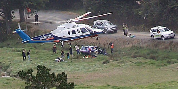 The Northland Emergency Helicopter lands at the scene of driver Ben Hunt's crashed rally car, airlifting Hunt and co-driver Tony Rawstorn to Whangarei Hospital, after their car crashed on the Helena Bay stage of the International Rally of Whangarei on Saturday. Photo / John Stone