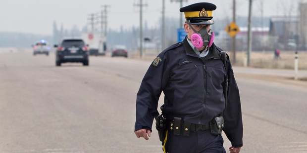 Police officers controlling traffic protected themselves against the smoke.