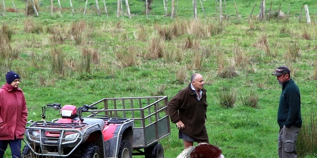 Kaitoke farmer Tony Skews, centre, talks to neighbours about the mutilated carcass left on his property. Photo / Stuart Munro