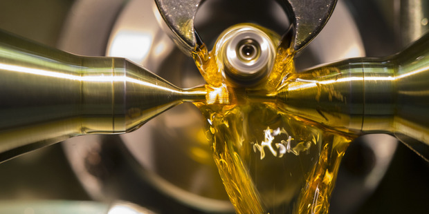 Oil flows as indentations are bored into a luxury wristwatch toothed wheel. Photo / Bloomberg