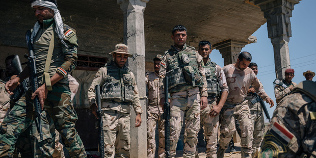 Iraqi Army soldiers in Kharbadan, Iraq, trying to recover land from Isis. Photo / Washington Post