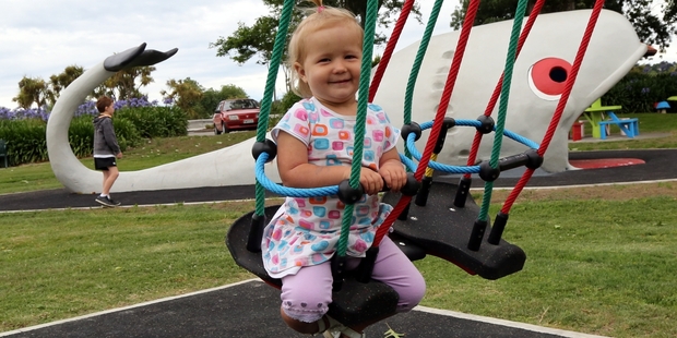 LITTLE SWINGER: One-year-old Danielle Stewart tries out one of the new swings.