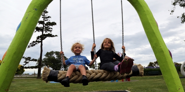 Christian Stewart, 4, and sister Hayley, 7, enjoy the new swing attached to the snake at Kowhai Park