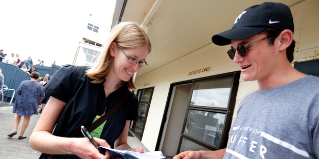 NZME reporter Kim Fulton gets a tip from Robert Logan, son of famed Northland trainer Donna Logan and the late Dean Logan before placing her winning bet at the Ruakaka Races yesterday. Photo / John Stone