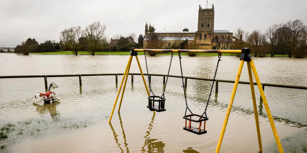 A playground lays deserted, flooded after prolonged heavy rain in Gloucester. Photo / AP