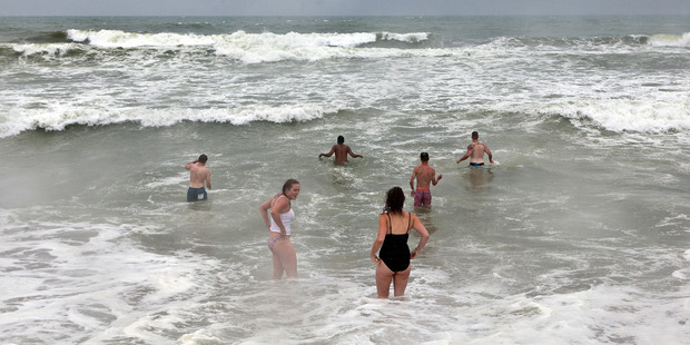 Holiday makers swimming in the sea on Saturday despite the rain.