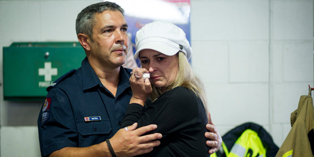 "You are all heroes." - Cherie Kingi hugs firefighter John Duell. Photo / Dean Purcell