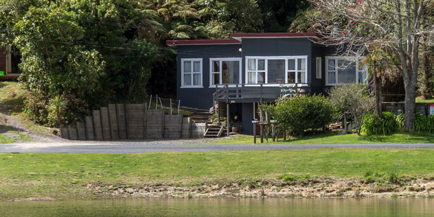 This gorgeous 1950s bach is right on the lake front in hidden Otautu Bay, Lake Rotoehu. Photo / Supplied
