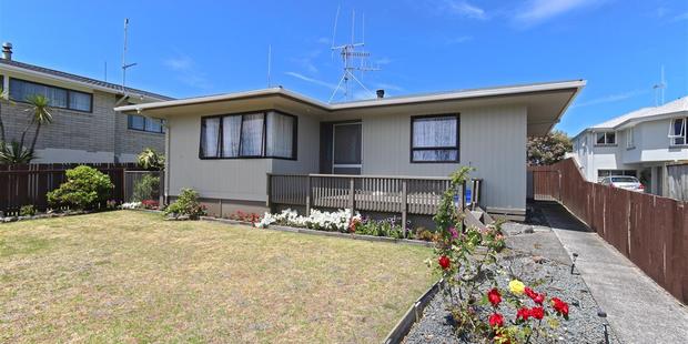 The property has a double garage and plenty of space on the front lawn for tents. Photo / Supplied