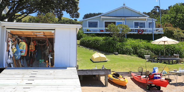 This Arran Bay, Waiheke Island getaway has it all: beach, boatshed and bach. Photo / Supplied