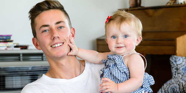 Noa Woolloff, 17, with his 9-month-old daughter Kyla in Plimmerton. Photo / Mark Coote