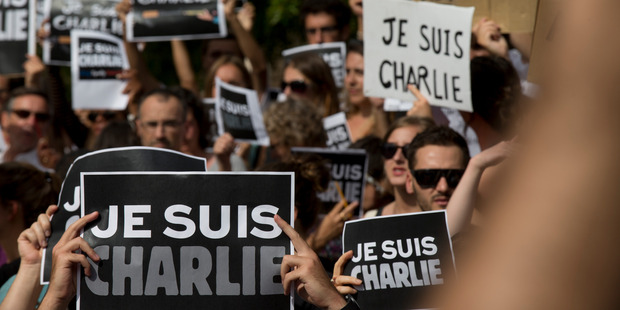 A vigil was held in remembrance of the 12 people who died in the Charlie Hebdo shootings in Paris. File photo / AP