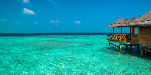 Over-water bungalows with steps into an amazing green lagoon in Tahiti.