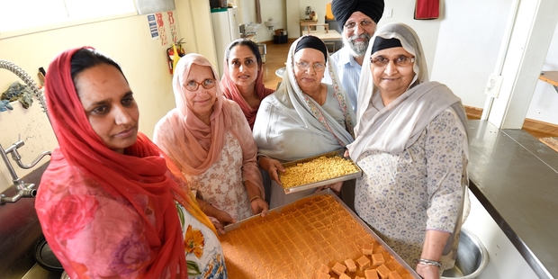 Gurdwara Sikh Sangat Tauranga members: Sandeep Kaur (left), Gyan Kaur, Ramandeep Kaur, Balbir Kaur, Puran Singh and Sukhdev Kaur preparing sweet treats for the street parade. Photo / George Novak