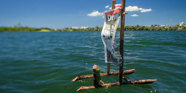 A flax boat with a flax captain on Lake Pupuke. Photo: Ted Baghurst