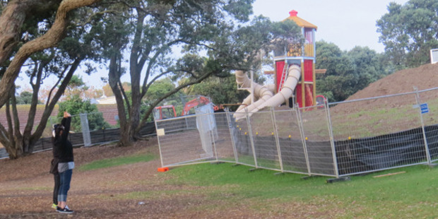 Tai Chi practitioners dwarfed by the playground structures.