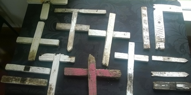 Some of the discarded crosses have identifiable names or plaques attached. Photo / Auckland Council