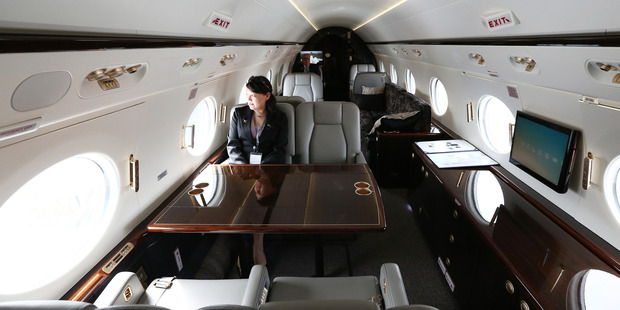 An employee sits inside a Gulfstream G450 business jet. These planes cost US$57 million. Photo / Getty