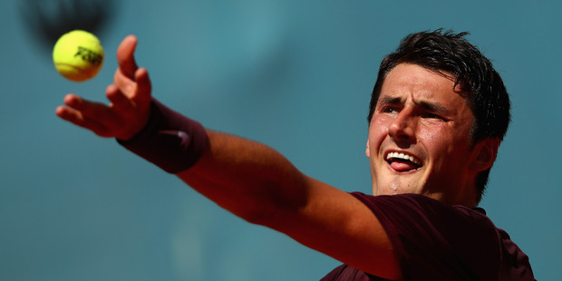 Bernard Tomic serves against Fabio Fognini of Italy. Photo / Getty Images