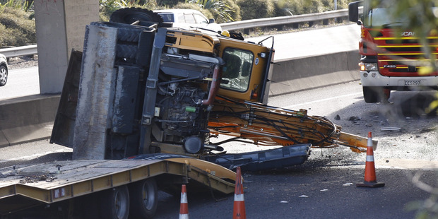 A lorry carrying a high bucket collided with a Penrose highway overpass on a southern motorway, southbound. Photo / Nick Reed