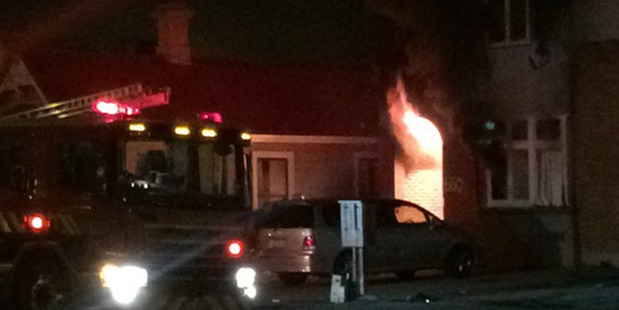 Fire officers attend the scene of a fire at 660 Castle St Dunedin. Photo / Supplied
