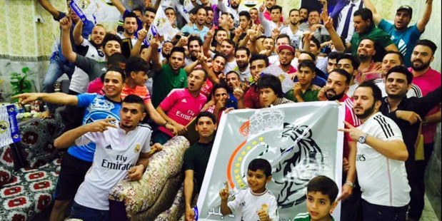 Real Madrid fans pose for a group photograph taken a few days before their headquarters were attacked by Isis. Photo / Steven Nabil